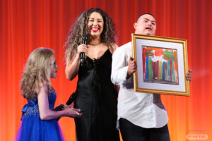 Hector and his sister presenting his painting of the Fountains of Bellagio during the live auction.